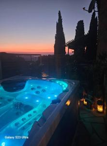 a large swimming pool with a sunset in the background at Le Château de Soleil in Saint-Pons-de-Mauchiens