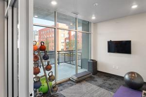 a room with a gym with a view of a building at Gorgeous 2BD 2BA Pool,Gym,Htub near Convention Ctr in Salt Lake City