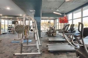 a gym with a bunch of treadms and machines at Gorgeous 2BD 2BA Pool,Gym,Htub near Convention Ctr in Salt Lake City