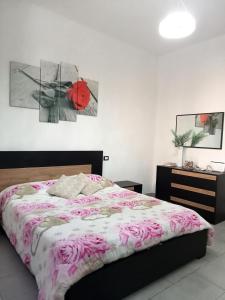 a bedroom with a bed with a red umbrella at My house in Piombino
