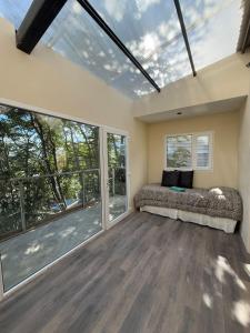 a large room with a bed and large windows at Casa Bosque in Ushuaia
