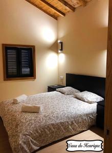 a bedroom with a bed with two pillows on it at Casa do Henrique in Bragança