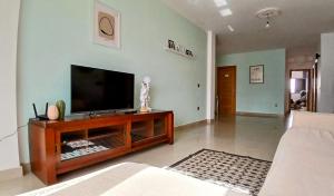 a living room with a flat screen tv on a table at La Casita Suites in Puerto del Rosario