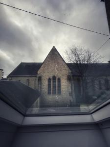 a view from a window of a brick church at Grande maison moderne 5 chambres in Cherbourg en Cotentin