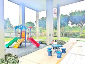 a playground in a building with children playing on slides at LPN Premium Apartment Pattaya in Pattaya North