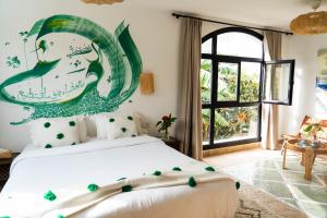 Кровать или кровати в номере RIAD OASIS D'ASILAH