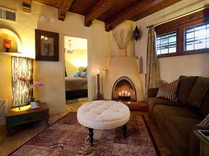 a living room with a couch and a fire place at Casa de Tres Lunas/House of Three Moons in Santa Fe