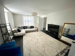 a living room with a couch and a television at 5 Bedroom Detached House in Milton Keynes in Bletchley