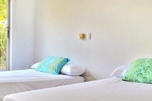 two beds sitting next to each other in a room at Casa Finca Jaccuzi Aire Acondicionad Wifi TV in Ricaurte +26 photos