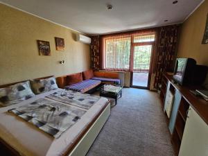 a living room with a bed and a couch at Family Hotel Jeri in Velingrad +35 photos