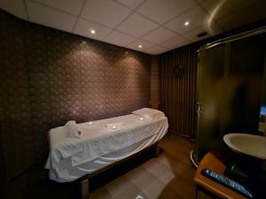 a small bathroom with a tub and a sink at Family Hotel Jeri in Velingrad