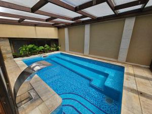 a large swimming pool in a room with a pool at Family Hotel Jeri in Velingrad