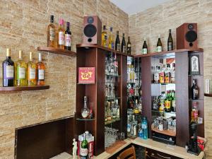 a bar with bottles of alcohol on the wall at Family Hotel Jeri in Velingrad