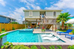 a home with a swimming pool and a house at Paix Bleu- Heated Pool & Spa Pet Friendly in Galveston