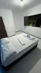 a large bed in a room with at Pousada São João in Jericoacoara