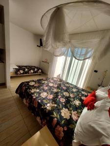 a bedroom with two beds and a window at Regina Margherita in Rimini