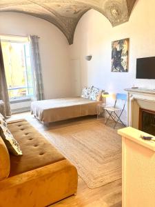 a living room with a bed and a couch at Studios - Menton Old Town - near the beach and shops in Menton