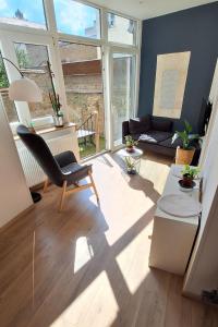 a living room with a chair and a couch at Le Fiacre in Nancy