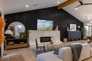 a living room with a couch and a fireplace at The White House in Caledonia