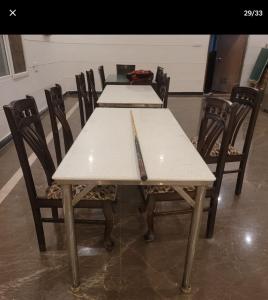 a set of tables with chairs and a knife on top at Grandvill Resort in Bengaluru