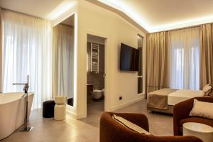 a hotel room with a bed and a bathroom at Mamalu - Corso Umberto 35 in Naples