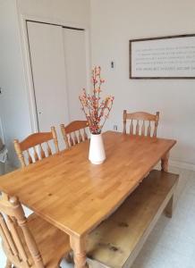 a wooden table with a vase with flowers on it at Pocono Cabin Fireplace Near Skiing Tubing Parks Shopping Casinos in Pocono Lake