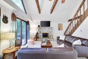 a living room with a leather couch and a fireplace at Pocono Cabin Fireplace Near Skiing Tubing Parks Shopping Casinos in Pocono Lake
