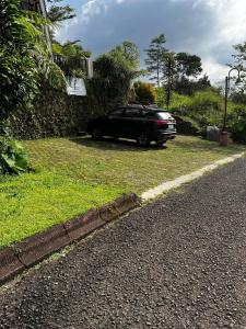 a black car parked on the side of a road at Villa Eriyana in Ciater +7 photos
