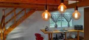 a kitchen with three lights hanging from the ceiling at Casa Juani in Quequén