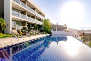 a villa with a swimming pool in front of a building at One2Seven in Ferragudo