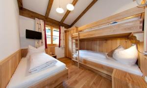 a room with two bunk beds and a tv at Tauernchalets in Grossarl