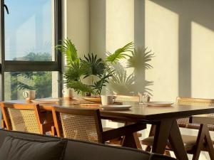 a dining room with a table and some plants at Nature & Pool view Condo 3R3B IOI Resort Putrajaya in Putrajaya