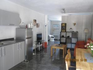 a kitchen and a living room with a refrigerator at Chalet Atalants Yailja in Alcossebre +23 photos