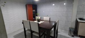 ein Esszimmer mit einem Tisch und zwei Stühlen in der Unterkunft Casa em Tramandaí in Tramandaí + 4 Fotos