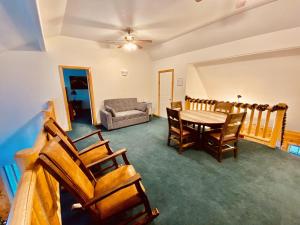 a living room with a table and chairs and a couch at Beautiful Lodge And River Ranch Property For Up To 120 People in Fort Bridger +32 photos