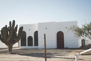 a white building with a cactus in front of it at K NAJ Community in El Quelele
