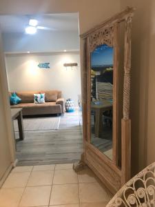 a mirror in a living room with a couch at Castaway at Boat Harbour in Boat Harbour
