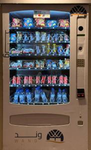 a vending machine filled with drinks and water bottles at فندق وند wand hotel in Khawājīyah +27 photos