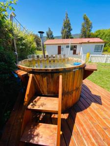 a wooden barrel table with glasses on top of a deck at Casa Haciendado de Lolol in Alto de Nerquihue