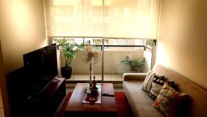 a living room with a couch and a window at Estadía Bertita in Talca