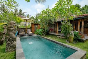 a pool in the yard of a house at Moringa Ubud Villa in Ubud