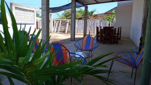 a group of chairs and a table on a patio at Hostal Jerusalema in La Punta de los Remedios