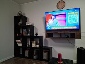 a flat screen tv sitting on a wall at Acogedor, cómodo y central. in La Serena