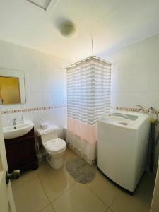 a bathroom with a tub and a toilet and a sink at Casa Haciendado de Lolol in Alto de Nerquihue