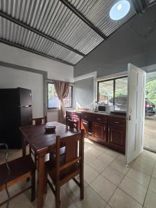 a kitchen and dining room with a table and chairs at Casita el Jardin in Nuevo Arenal