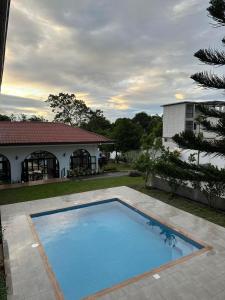 a large swimming pool in front of a house at R Villas Tagaytay across Balay Dako in Kaybagal