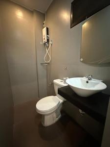 a bathroom with a white toilet and a sink at R Villas Tagaytay across Balay Dako in Kaybagal +18 photos
