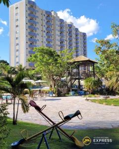 a pile of tennis rackets in front of a building at Flat em Caldas Novas no Golden Dolphin Supreme e próx Shopping Singapura com Utensílios e conforto in Caldas Novas +26 photos