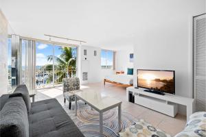 a living room with a couch and a tv at Ilikai Marina 6FL Ocean View & Marina, Renovated in Honolulu