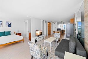 a living room with a couch and a tv at Ilikai Marina 6FL Ocean View & Marina, Renovated in Honolulu